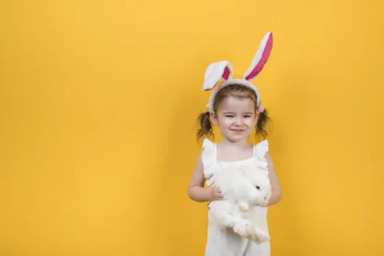 cute girl bunny ears standing with rabbit